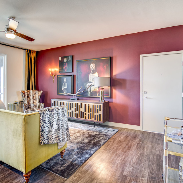 Douglas at Stonelake - Living Room with Bold Red Accent Wall and Wood Style Flooring
